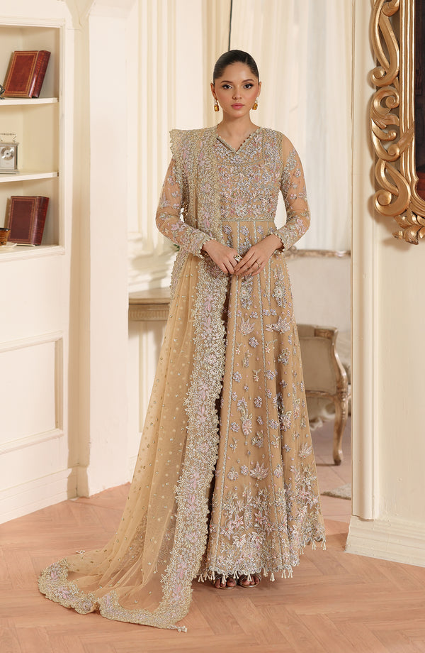 Woman in a traditional embroidered dress standing in a decorated room.