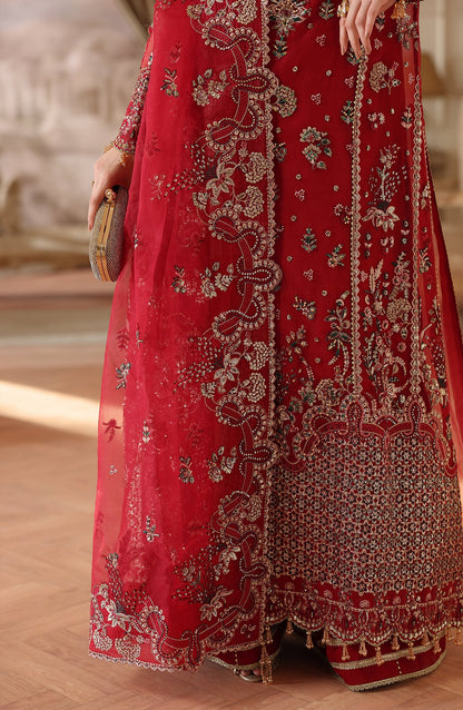 Red embroidered traditional outfit with intricate patterns on a wooden  Surkh Gulfloor.